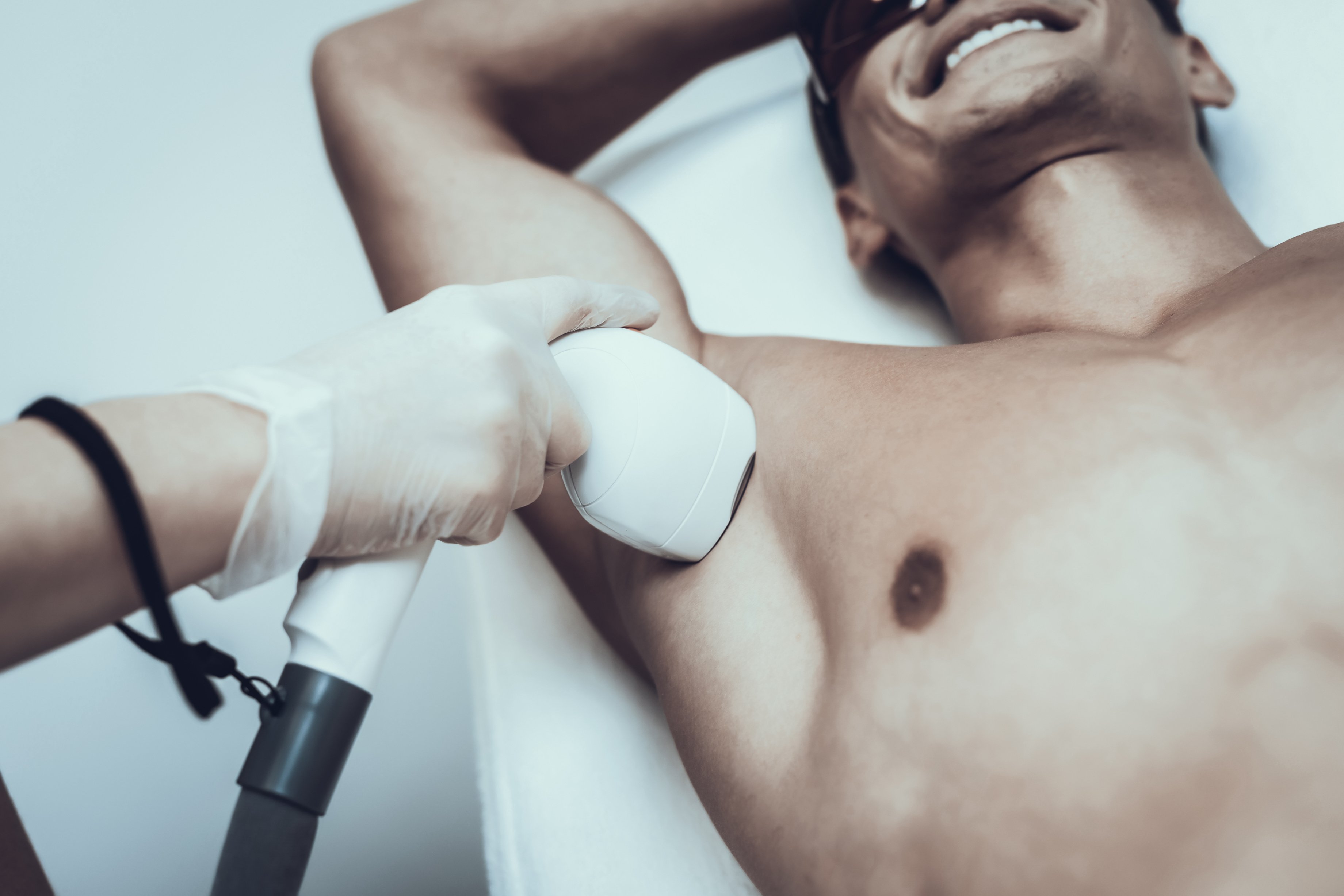 Young Man in Spa Salon for Laser Hair Removal.