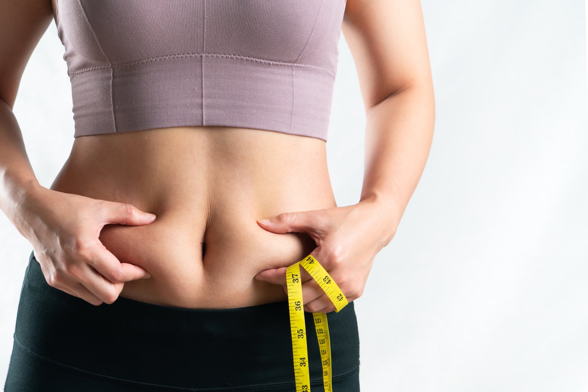 Woman Pinching Her Belly Fat